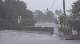 Floodwaters pour over Wilmington bridge
