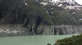 world's highest gravity dam with mountains and flowing water