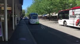 autonomous vehicle passenger shuttle driving down road