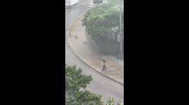 Man struggles to cross the street as Typhoon Mangkhut hits Hong Kong