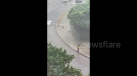 Man struggles to cross the street as Typhoon Mangkhut hits Hong Kong