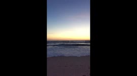 Wave and sunset at the beach in slow motion