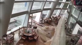 Hotel guests look on in horror as floodwaters crash into dining room