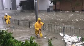 Residents tread through flooded streets as Typhoon Mangkhut brings torrential rains to Hong Kong