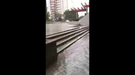 Resident walks on flooded pavement in Hong Kong in aftermath of Typhoon Mangkhut