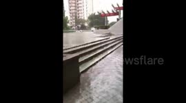 Resident walks on flooded pavement in Hong Kong in aftermath of Typhoon Mangkhut