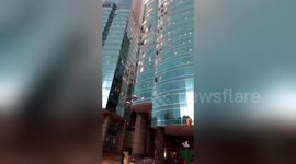 Windows of Hong Kong high-rise shattered after storm