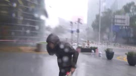 Moment pane of glass falls from tower close to TV reporter