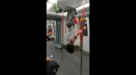 Man performs gymnastic routine, pull-ups and headstand on Hong Kong train