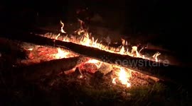 Logs on open fire at Camp site.