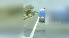 Moment HGV topples over in high winds on M6