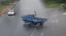Woman survives being struck by truck and sliding metres across slippery road