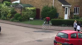 Crazy lady hoovering her lawn