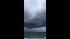 Ominous looking waterspout brings grey clouds to Philippines beach