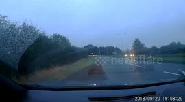 Cars drive around collapsed lamppost felled by Storm Ali winds