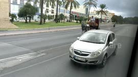 Horse drawn carriage on a major road in Malta