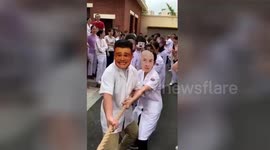 Paramedics wear funny masks during tug-of-war to disturb competitors