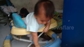 Indonesian baby try to escape from baby walker