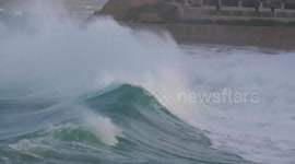 Big,Mega waves, crashing on the beach and soaking people.