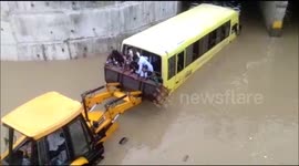 Locals rescue 35 children on bus stuck in flooded underpass