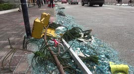 Workers clean up shards of broken glass after Typhoon Mangkhut blows out windows from Hong Kong high-rise
