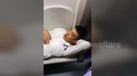 Lazy Chinese man lies across subway seats during peak time