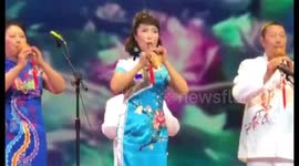 Woman plays traditional Chinese flute from the wrong end
