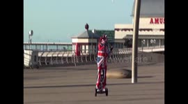 man dressed in Union Jack suit wheelies around Blackpool tower