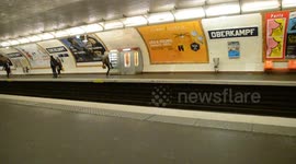 Angry woman kicking a drink machine after having paid and having her selection blocked. Paris, France, Metro train station Oberkampf