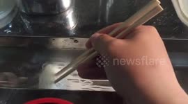 Diners catch their noodles from a flowing water trough in Japan