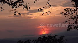 A beautiful sunrise over mountains and forest.
