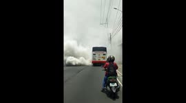 Bus stalls, emitting huge cloud of smoke that completely blocks traffic