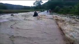 Video shows rushing floodwaters washing away locals' motorcycle in north India