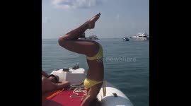 Husband tips wife overboard as she attempts headstand