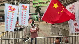 A Chinese demonstrator stands along in the Hong Kong National Day protest