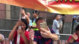 Pro China demonstrators line the path of the National Day march Hong Kong