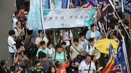 Joshua Wong and his fellow Demosistō party members pass the pro-independence camp during the National Day march Hong Kong