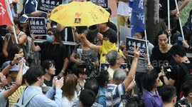 A pro Independence demonstrator holds one of the yellow umbrellas, the symbol of the Hong Kong Umbrella revolution, during the National March