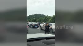 Woman gets out of car in highway gridlock to do Tai Chi