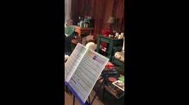 Poodle sings along during owner's saxophone lesson