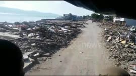 Drive through Palu, Indonesia shows rubble on both sides of road