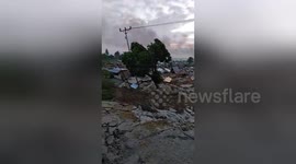 Palu residents stare at still-smoking ruins morning after magnitude 7.4 earthquake in Indonesia