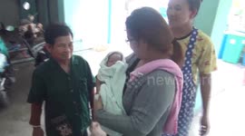 Newborn baby boy survives being 'thrown from balcony' after landing on banana leaves