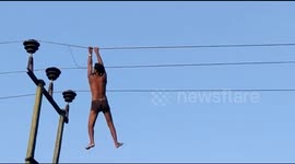 'Drunk' Indian man swings from high-voltage power lines