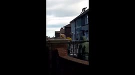 Half naked man on roof throws tiles at police
