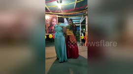 Touching moment young woman dances with teddy bear adorned with late father's face