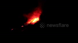 OCT. 4: Locals watch as lava erupts from Mount Soputan, Indonesia following the quake