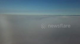 Drone camera pierces fog bank to reveal gorgeous clear sky