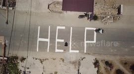 Indonesians chalk 'HELP' on ground as officials say search for victims to end