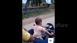 Toddler filmed riding a motorbike on a public road